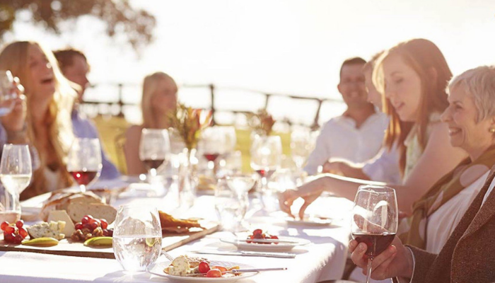 Large family gathered around table in Menorca